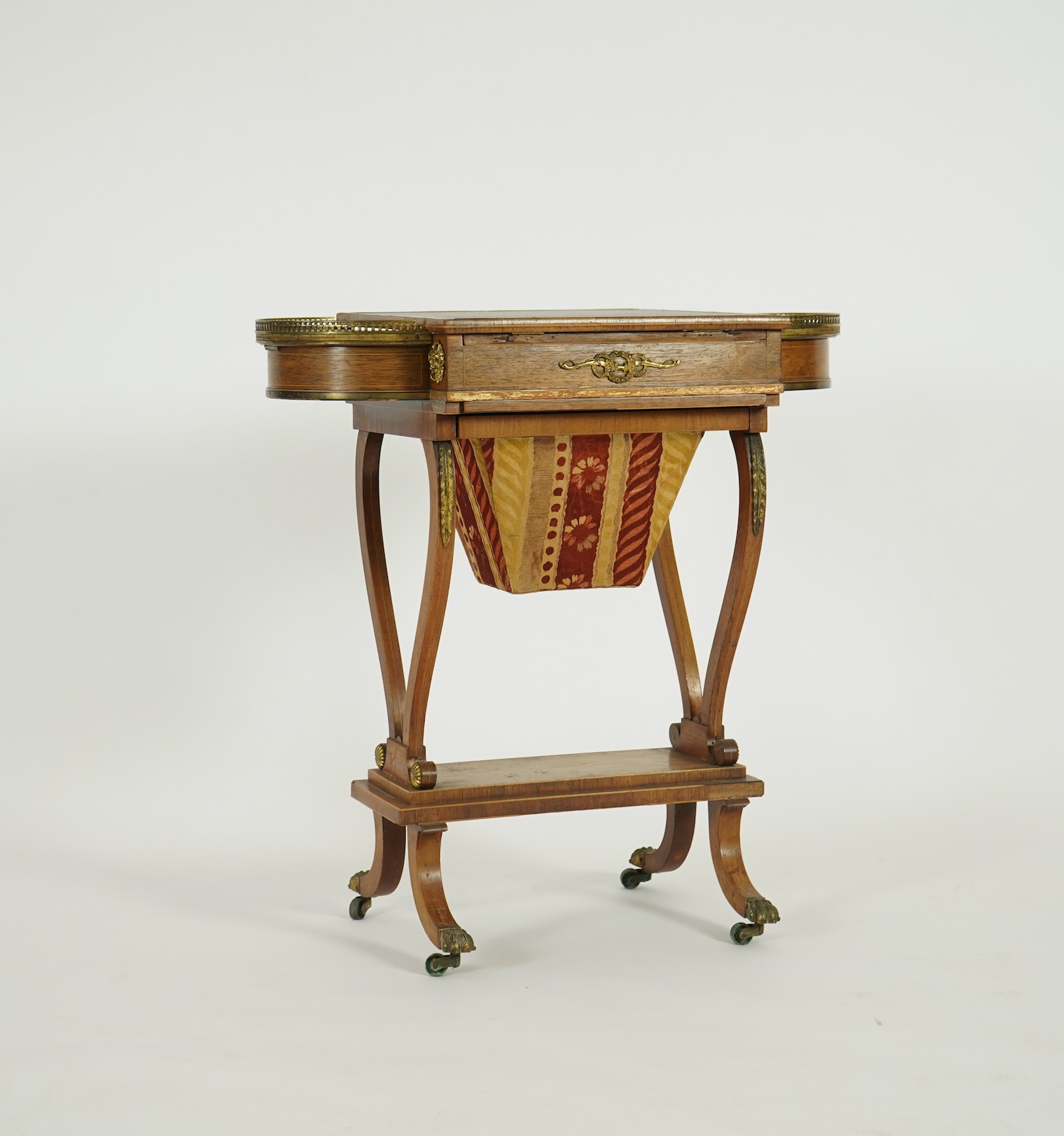A Regency brass mounted rosewood writing, games and work table